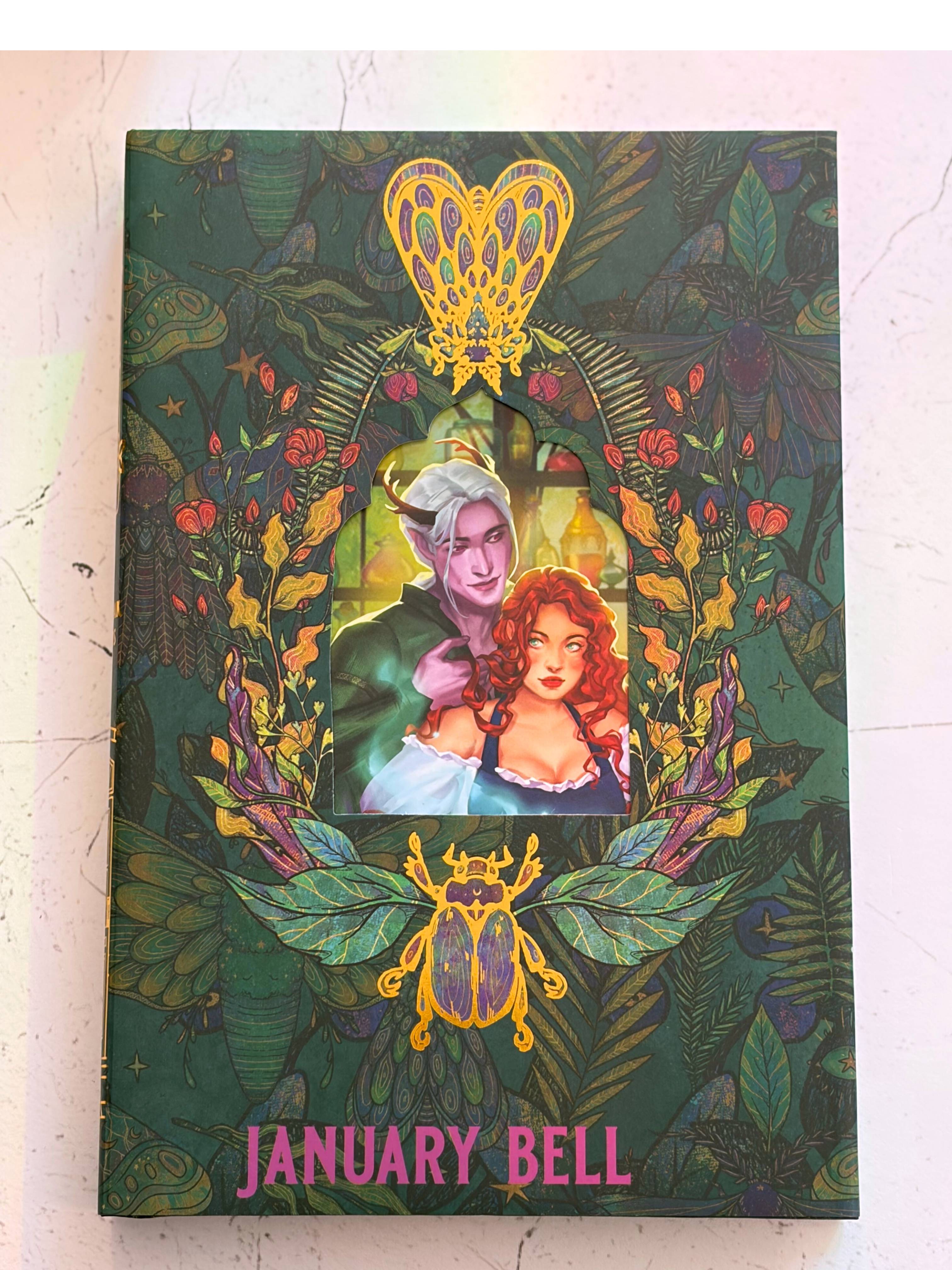 Book cover of How To Please A Princely Fae with illustration of a couple and 'January Bell' text on a green background