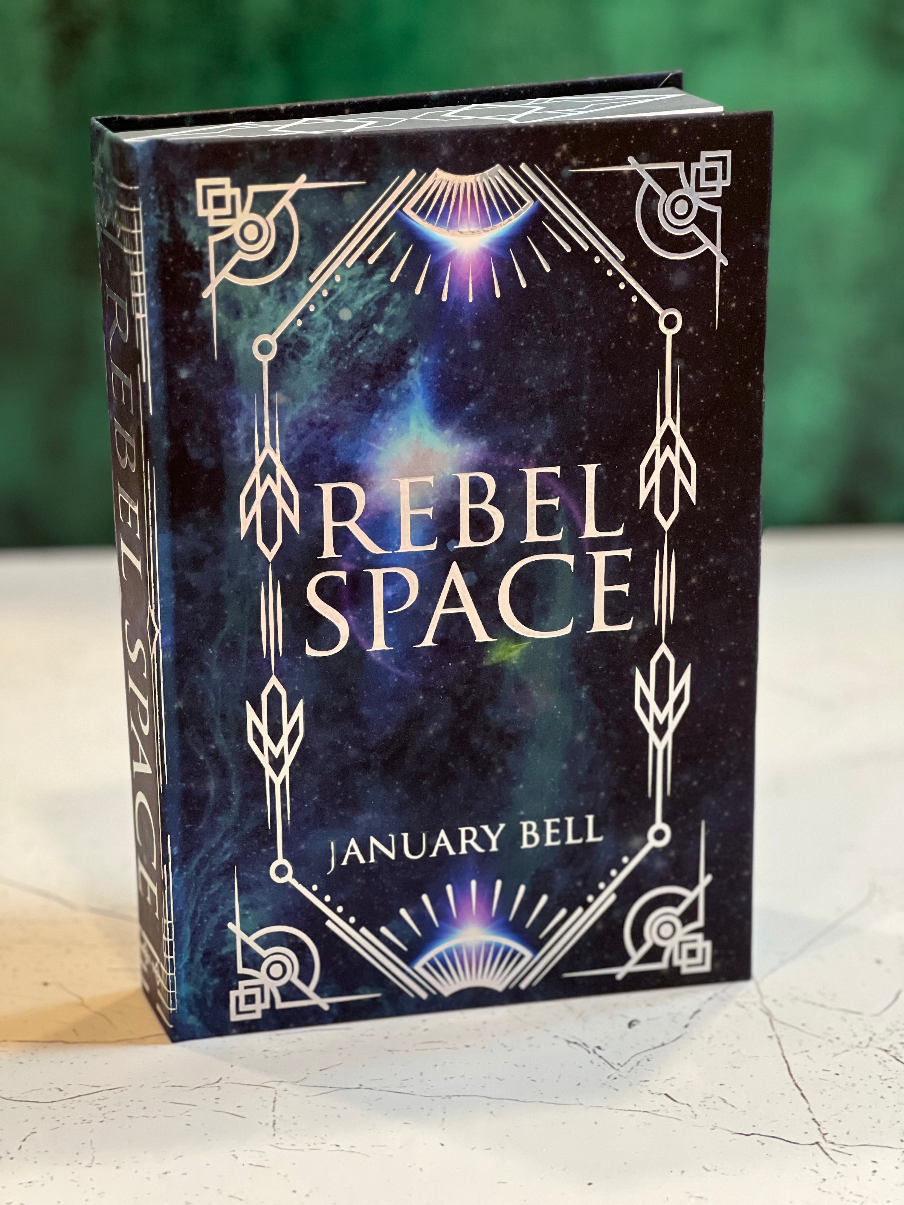 Book titled 'Rebel Space' by January Bell with a cosmic design on the cover.